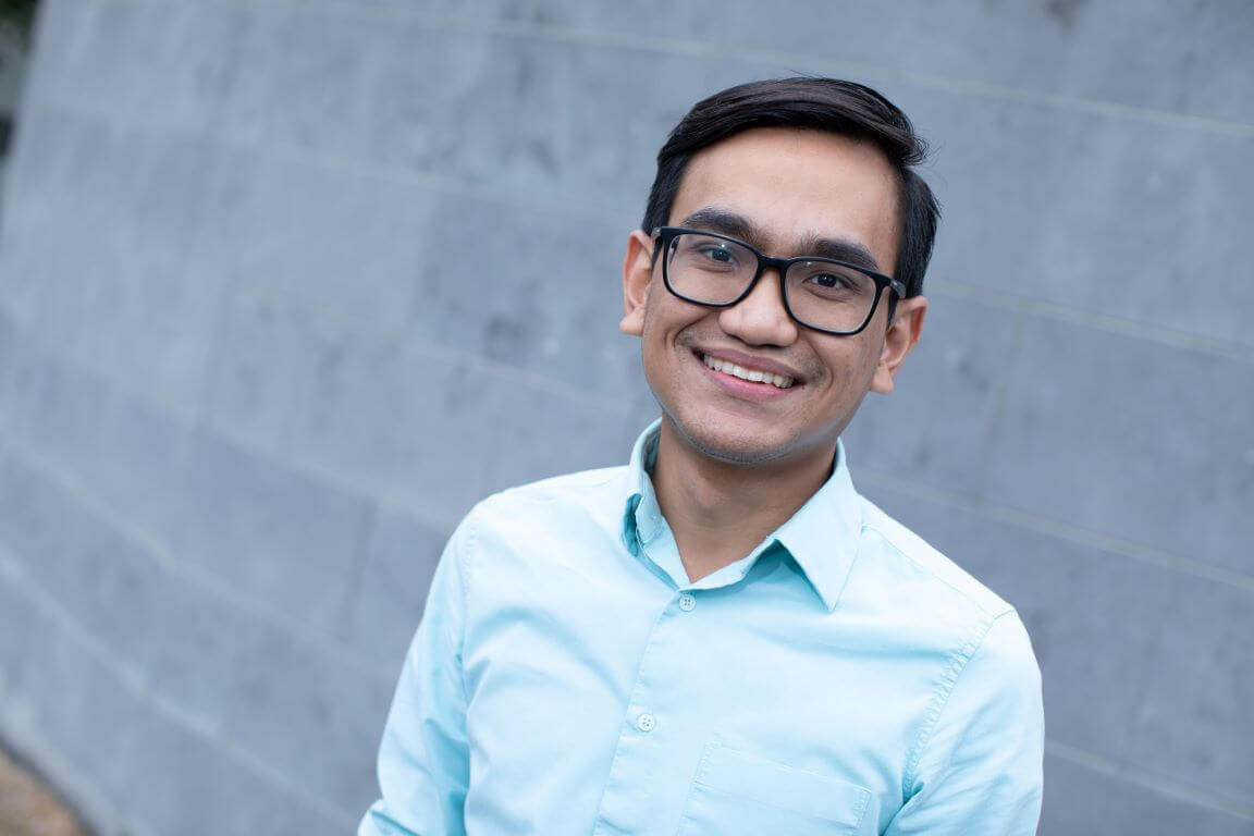 Male doctor outside smiling to camera